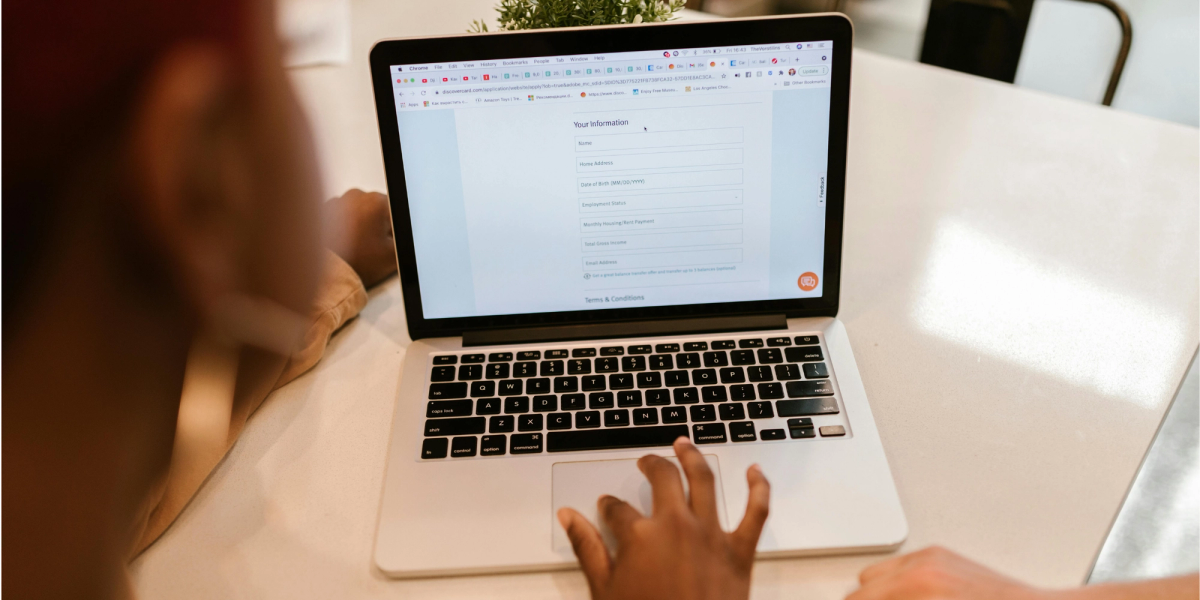 Alt text: Woman using laptop computer to complete a Google Form
